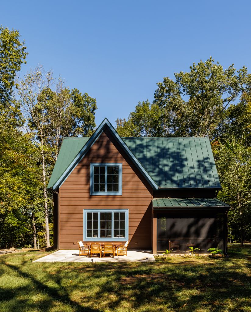 Dappled shadows from the forest around the house spread out over the facade.